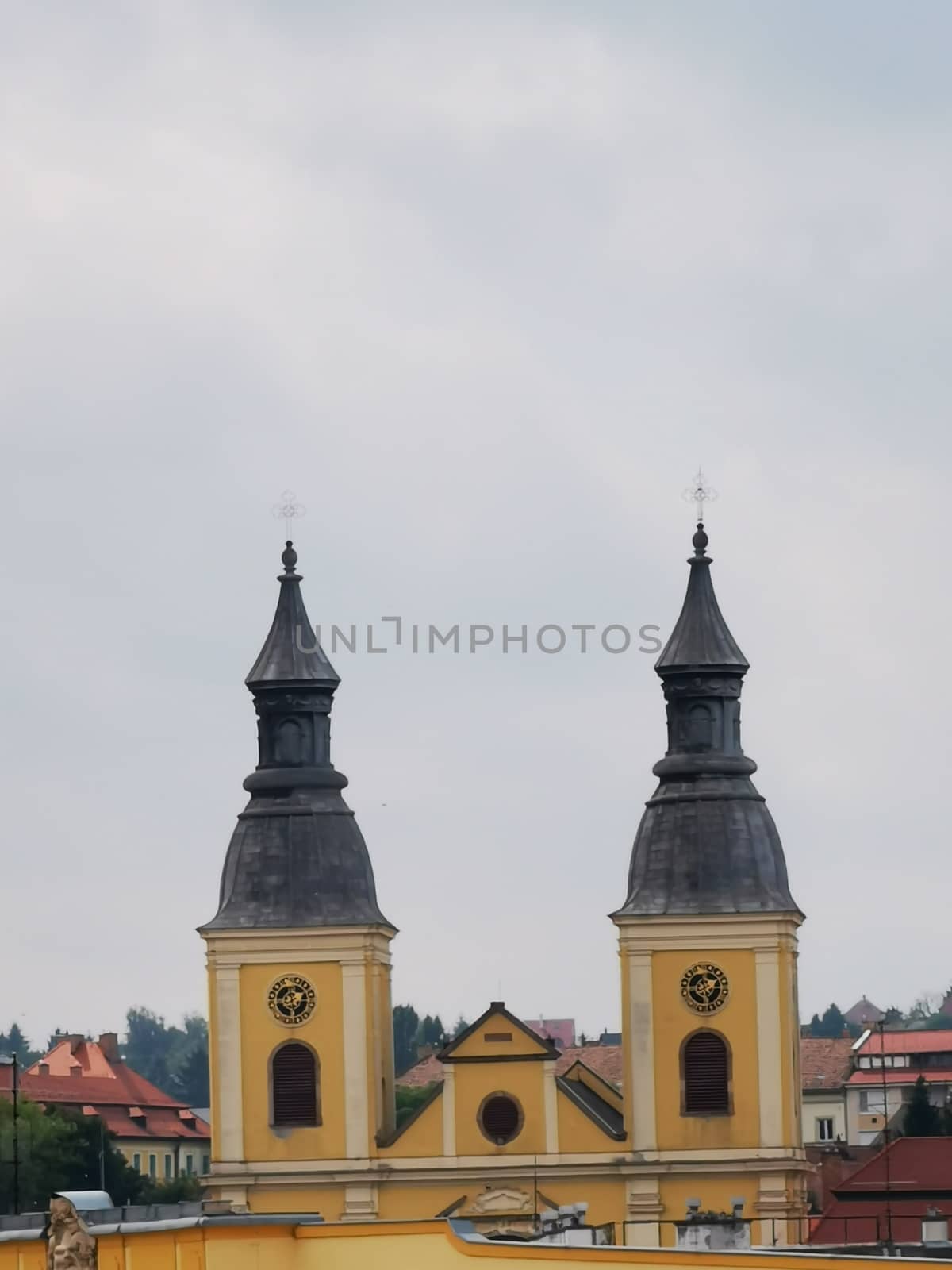 A clock tower in front of a building in Eger by balage941