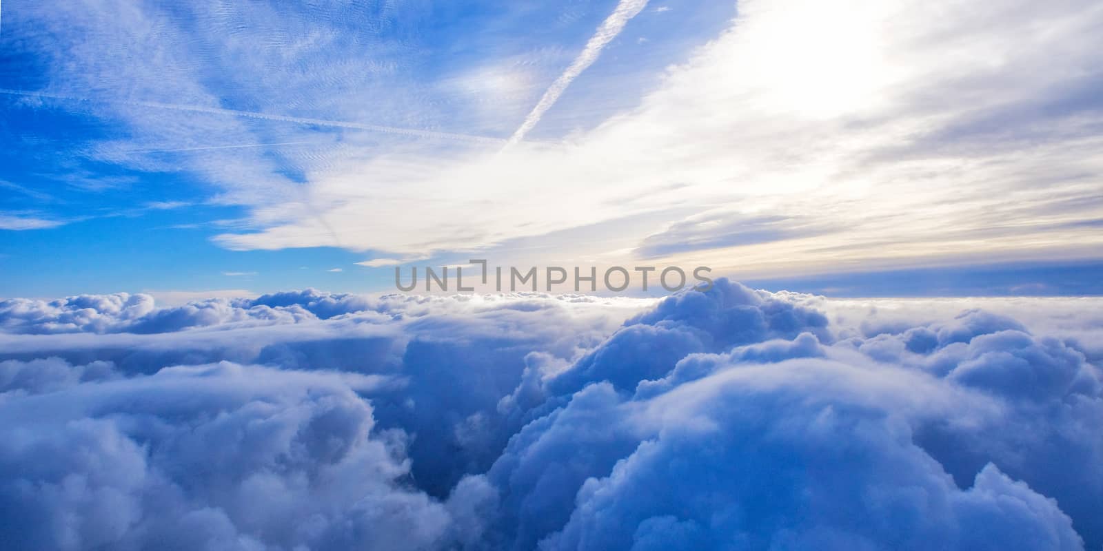 cloudy blue sky view from airplane window by Surasak