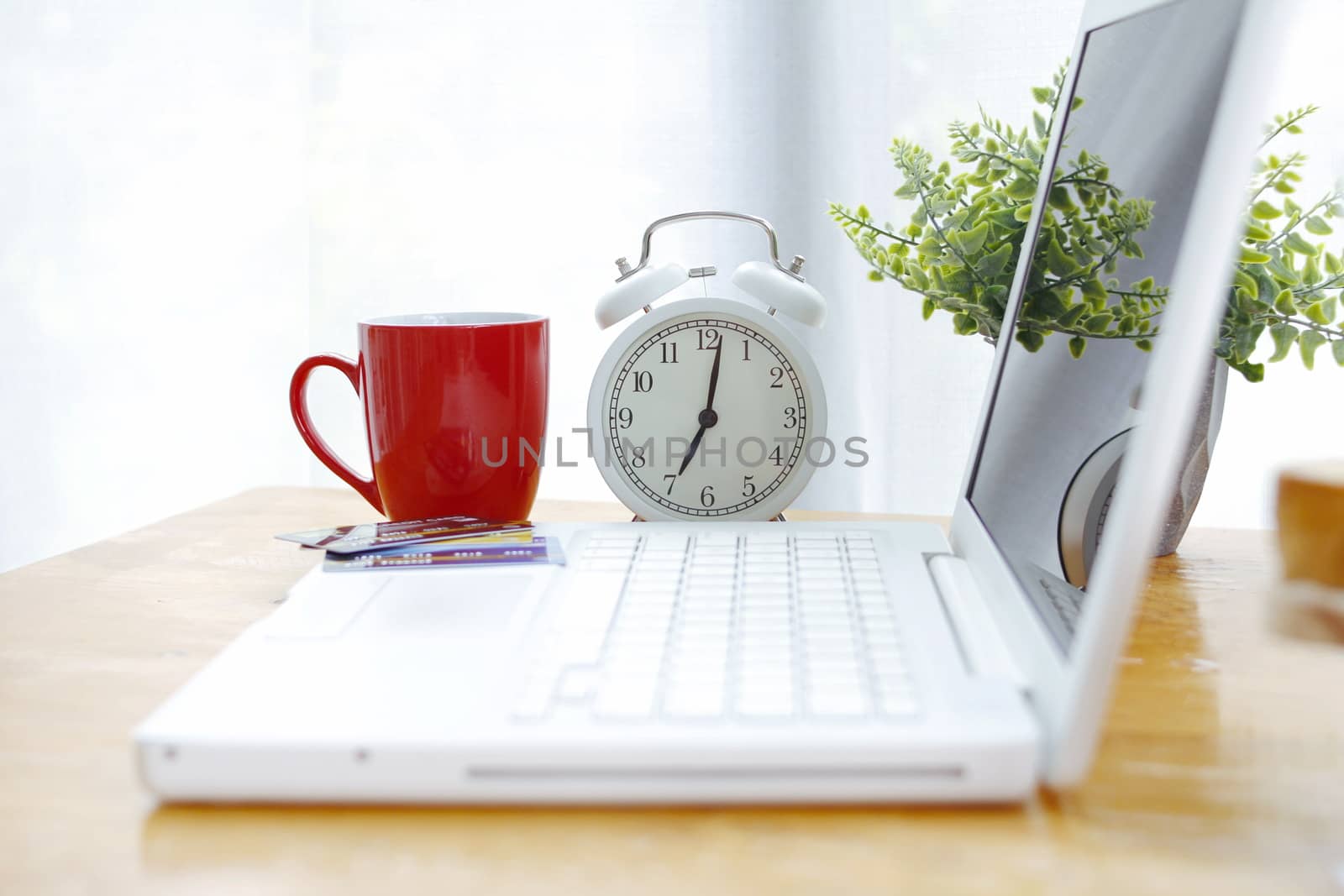 coffee cup with alarm clock Placed on the desk with a laptop by BirdKS