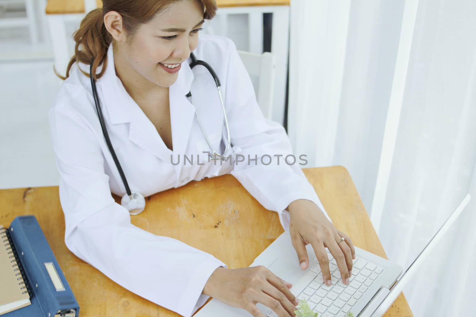 doctor is using a computer laptop.