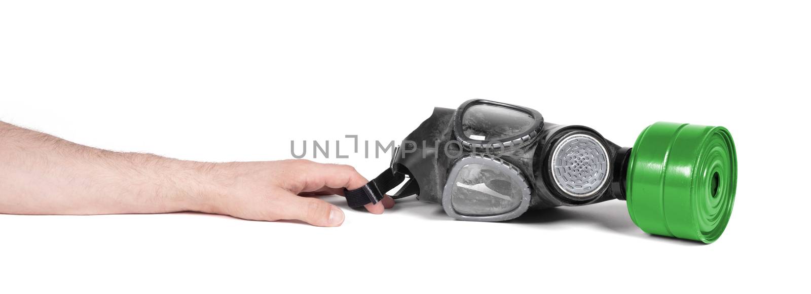 Arm reaching for vintage gasmask isolated on a white background - Green filter