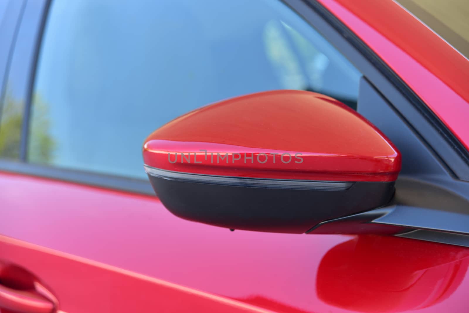 Car detail. Side mirror with turn signal of a luxury car