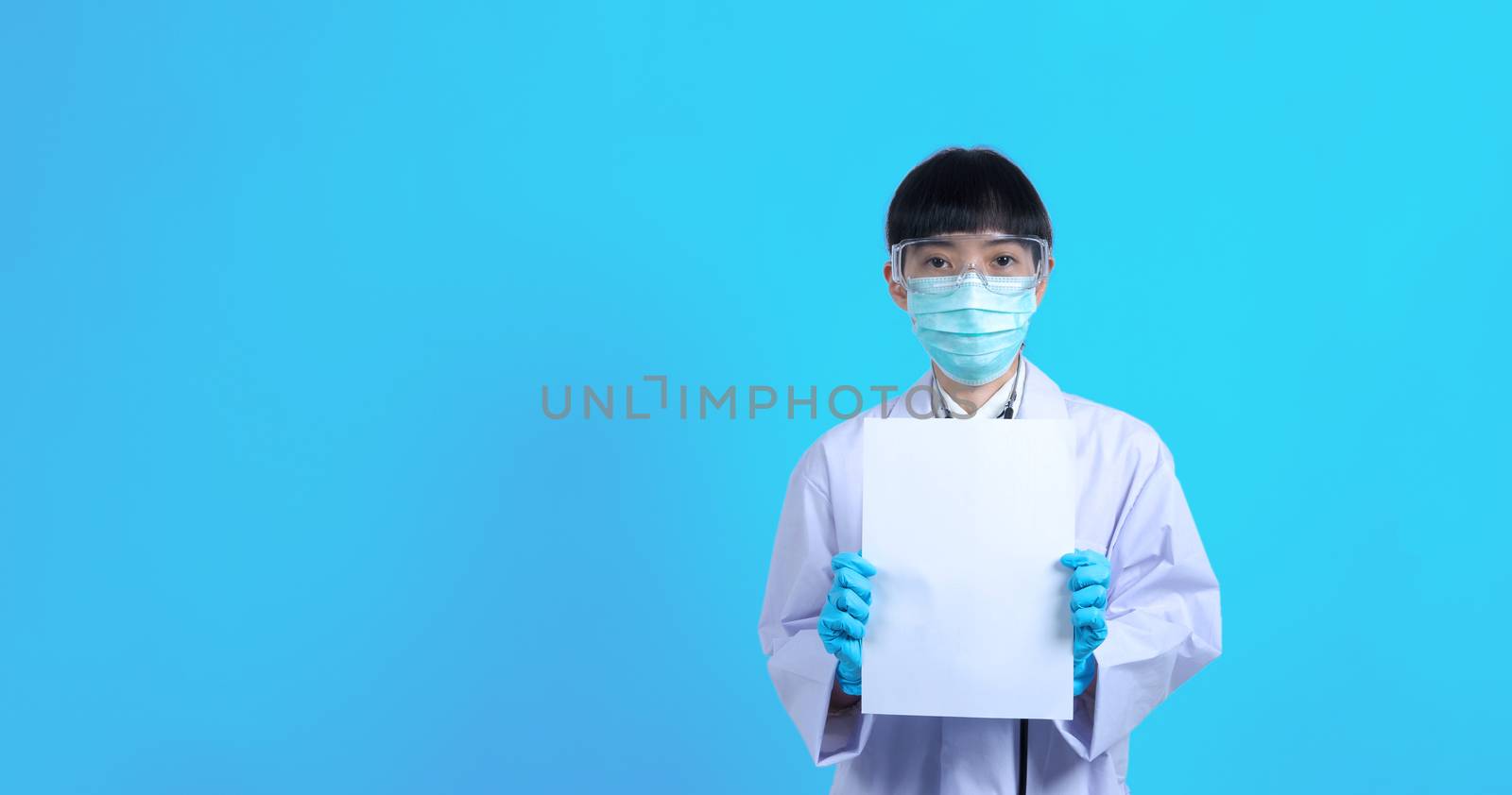 Asian woman doctor holding a blank paper in hand and copy space by gnepphoto