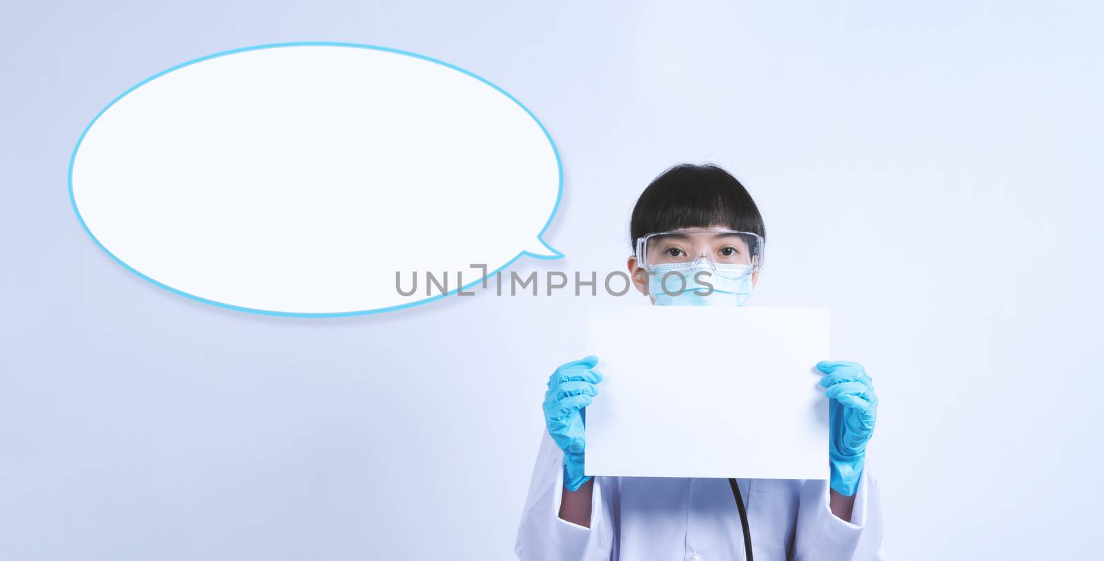 Asian woman doctor holding a blank paper in hand and copy space and she wear medical glove and face mask and doctor suit for protect virus pandemic. studio shot on plain background.