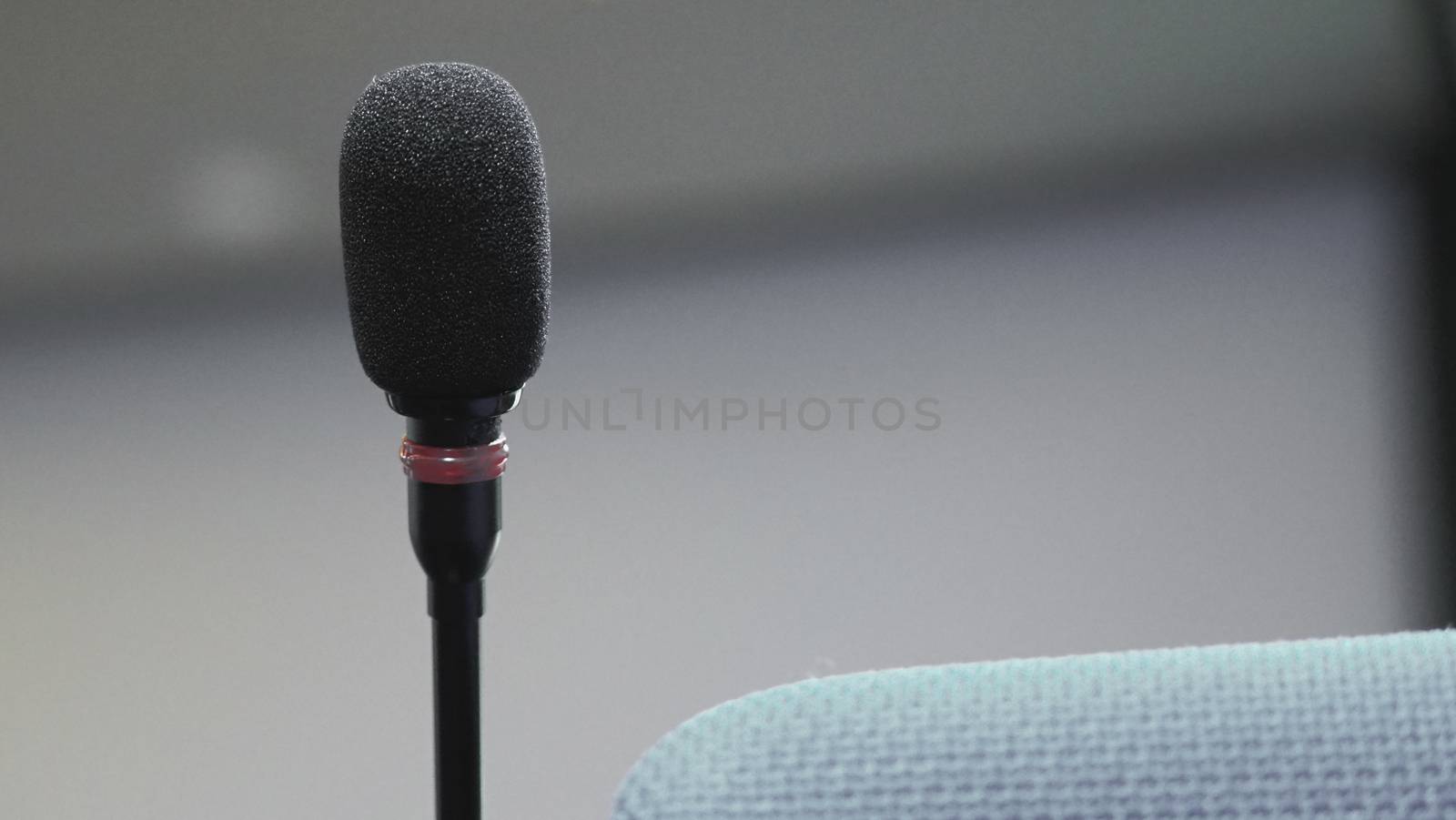 Mini microphone speaker in conference hall for speech in business seminar or organisation training or study and lecture and blurry images background.
