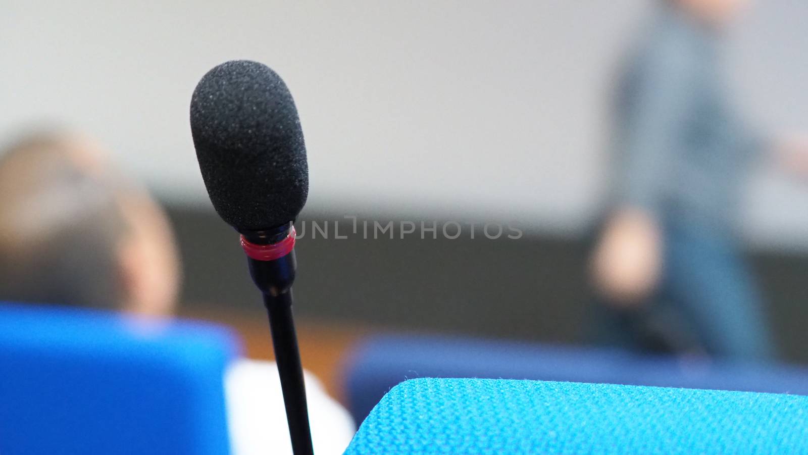 Mini microphone speaker in conference hall for speech in business seminar or organisation training or study and lecture and blurry images background.