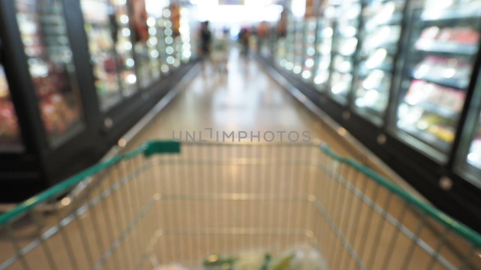 Blurry images of supermarket cart from people POV or point of view angle and shopping in the big hypermarket of Bangkok Thailand.