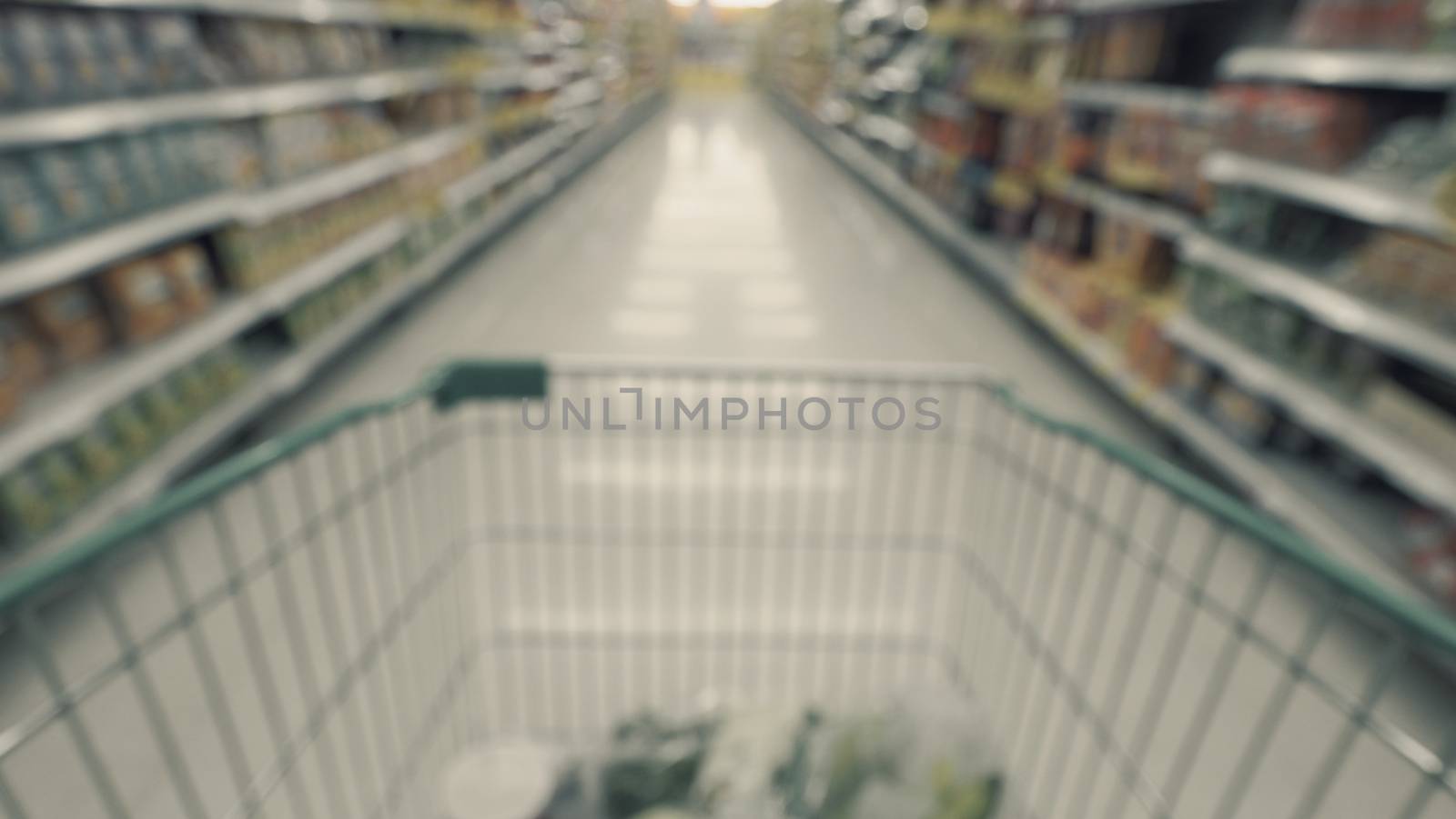 Blurry images of supermarket cart from people POV or point of view angle and shopping in the big hypermarket of Bangkok Thailand.