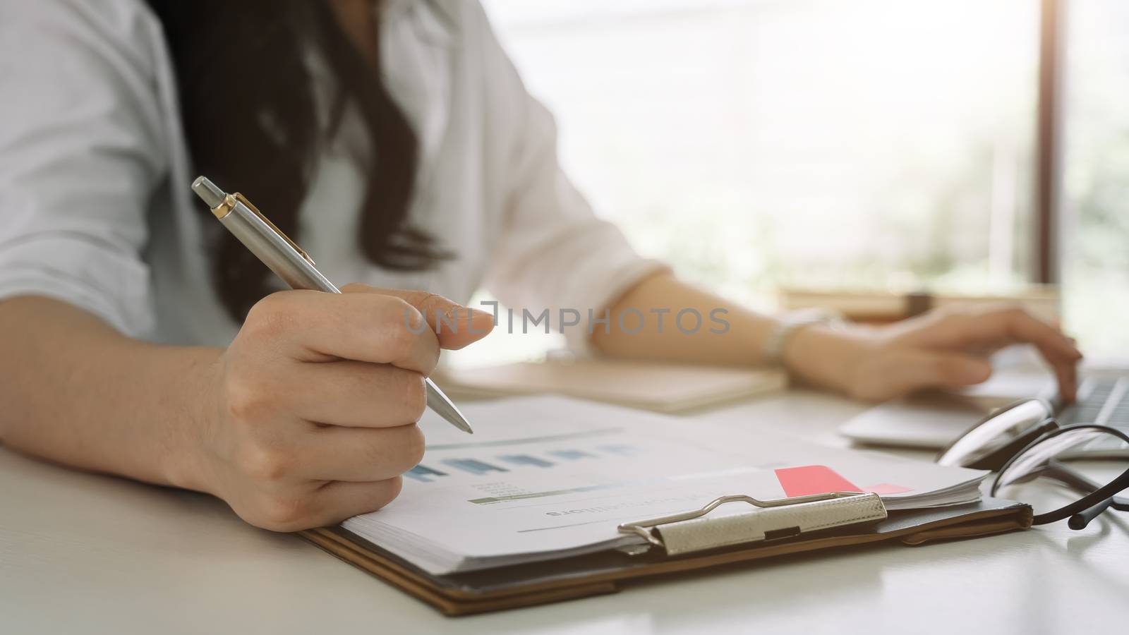 Business woman investment consultant analyzing company annual financial report balance sheet statement working with documents graphs. Concept picture of business, market, office, tax.