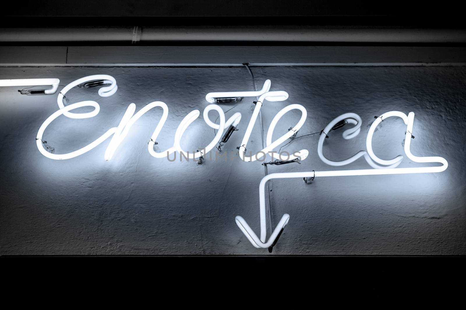 Blue neon signboard informs you of a italian winehouse.