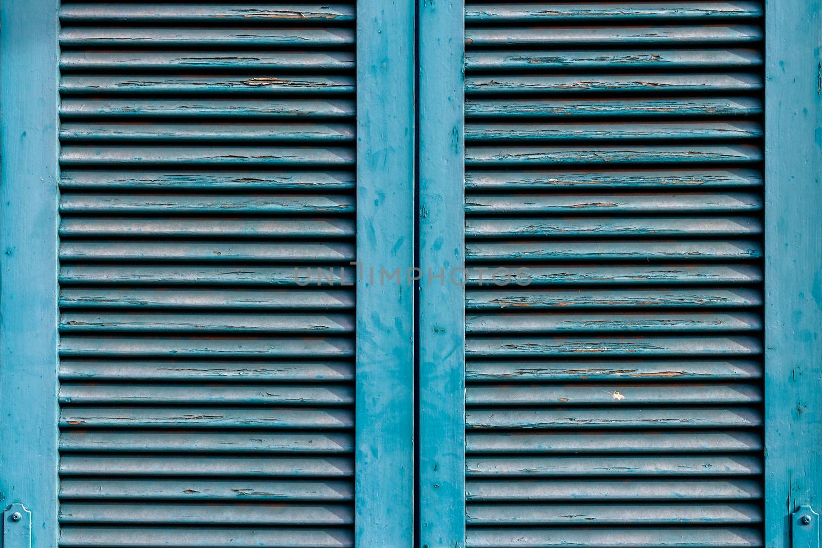 Front view of an old window closed, blue.