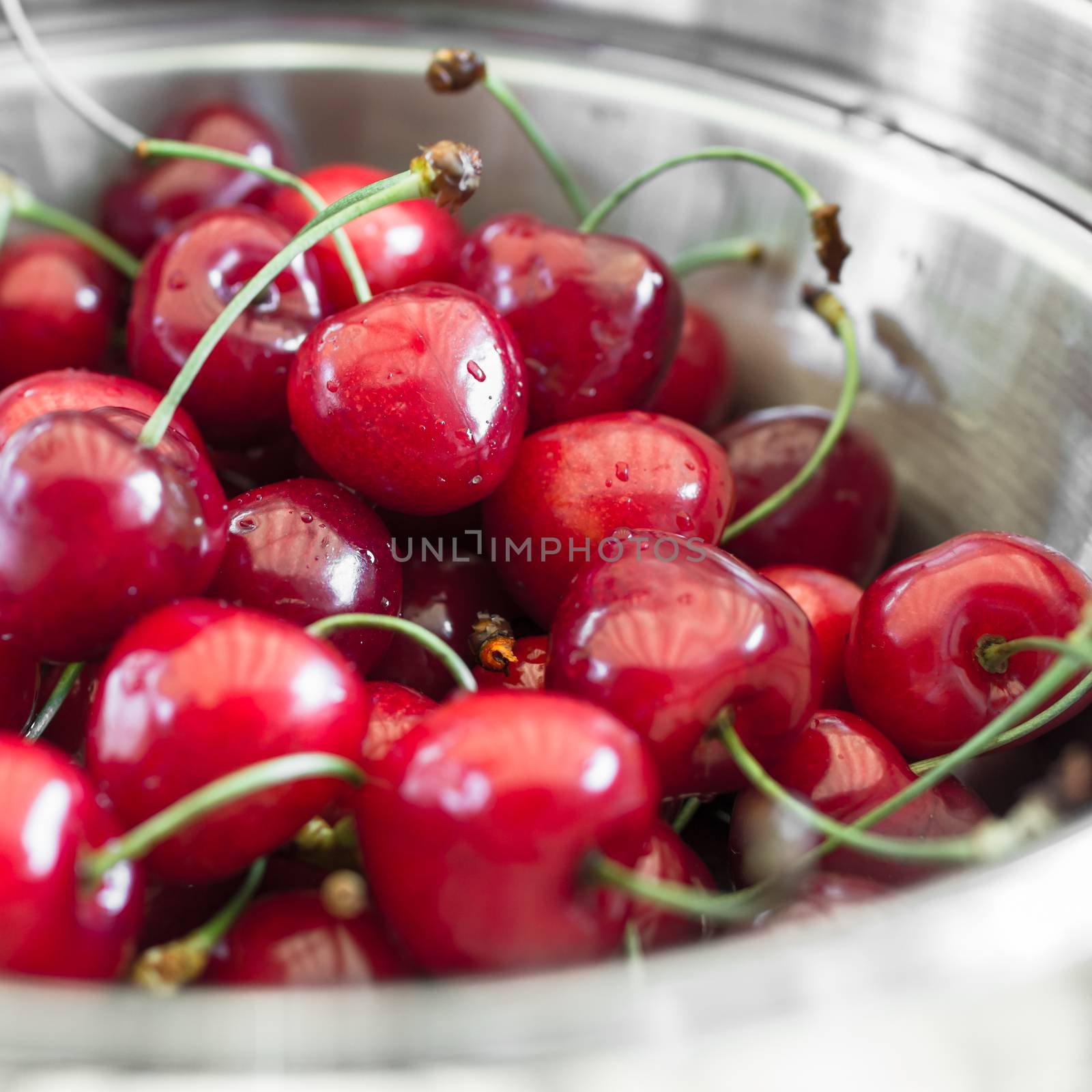 Close-up of amazing cherries served in a steel plate.