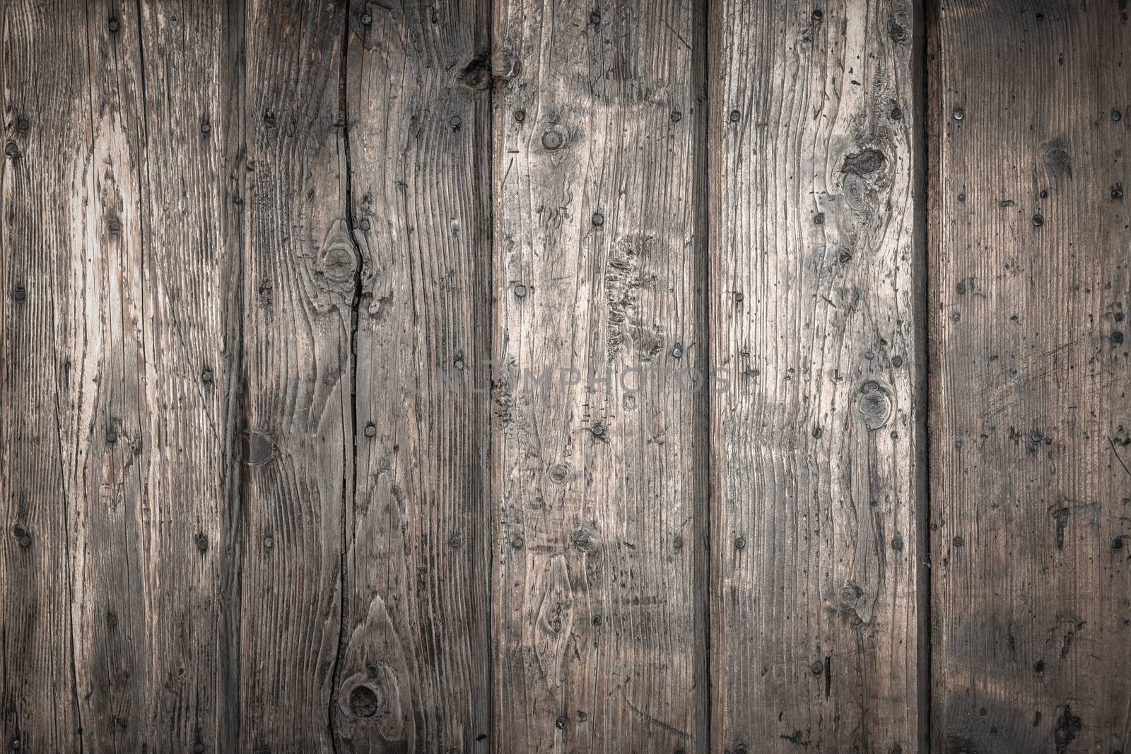 Rough wooden planks, dark and deteriorated by time.