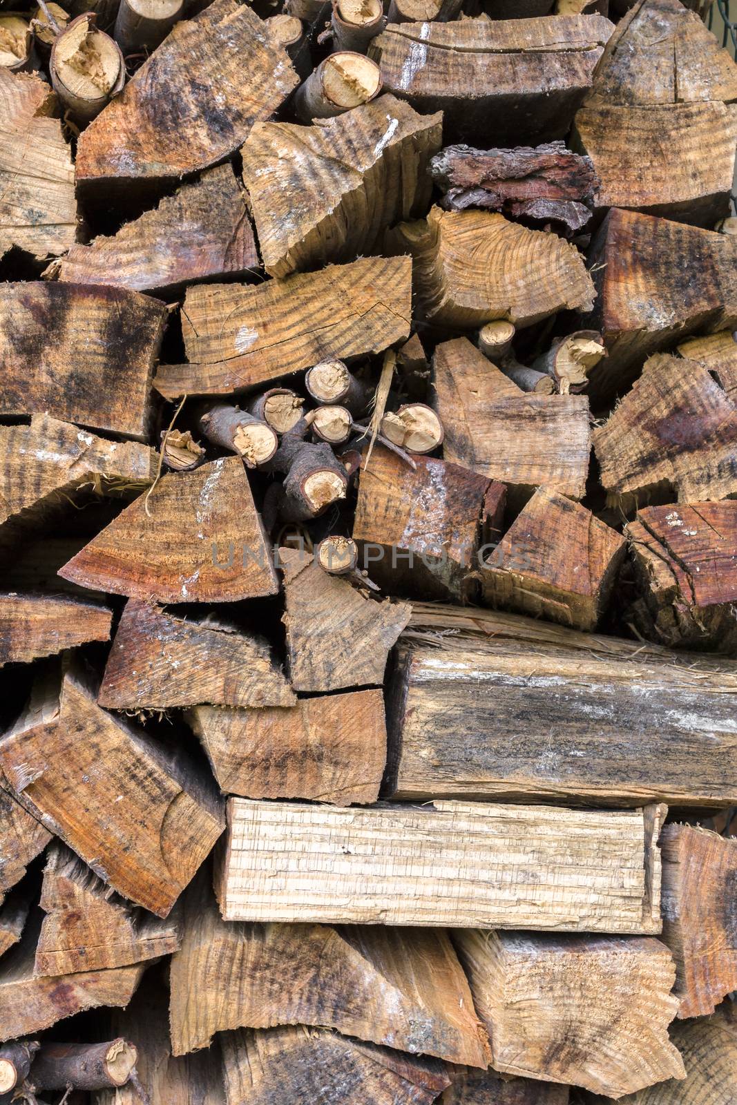 Lumber of various sizes stacked as a spare for the winter.
