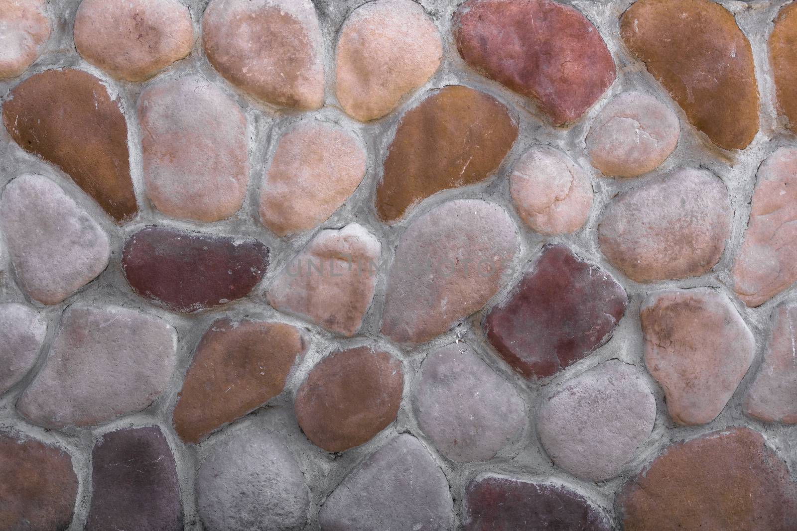 Stone wall composed of oval stones arranged in an irregular manner.