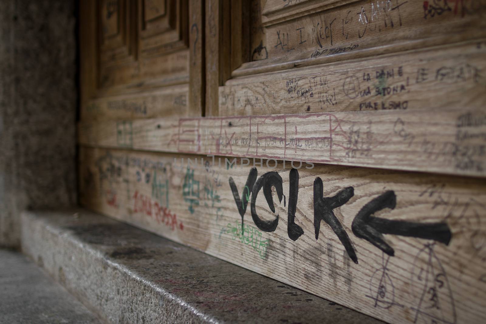 An old door covered with writing of any kind.
