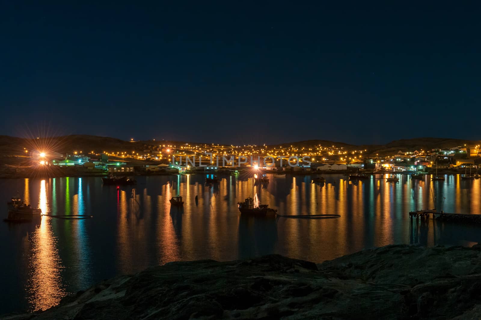 A night view of Luderitz as seen from Shark Island. Boats are visible