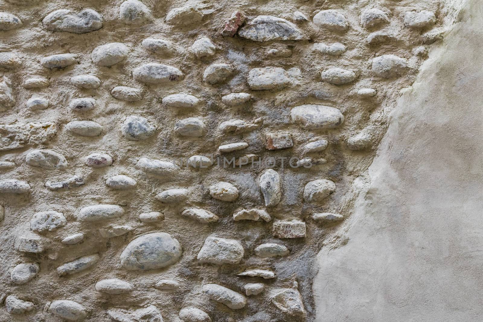 Stone walls partially covered by plaster.