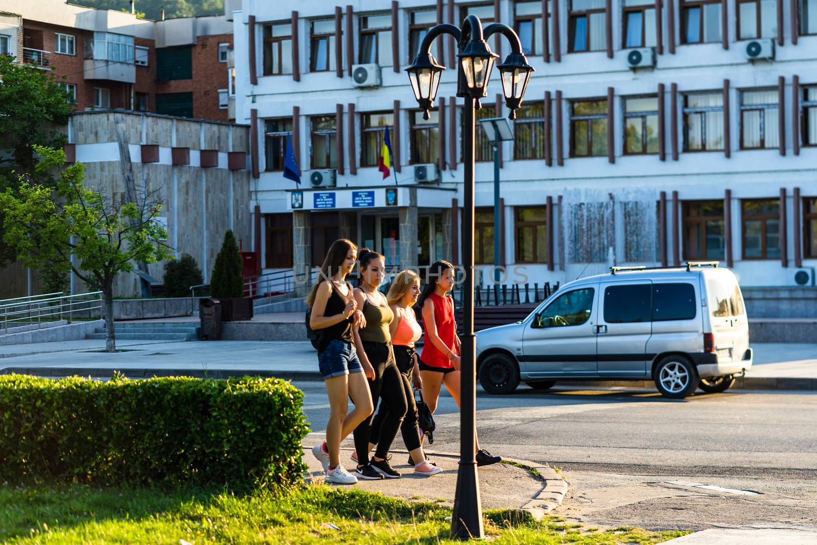 Group of teenagers walking on a street in Orsova, Romania, 2020