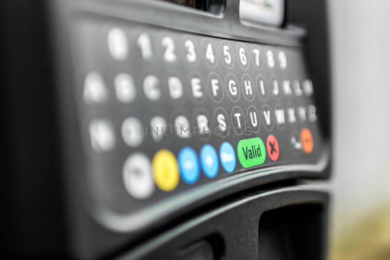 A parking meter with digital keyboard.