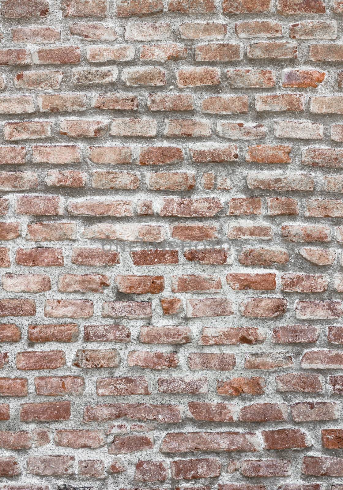 Fragment of a brick wall of an ancient structure. Exterior decoration of the building. A background for design and creative work.