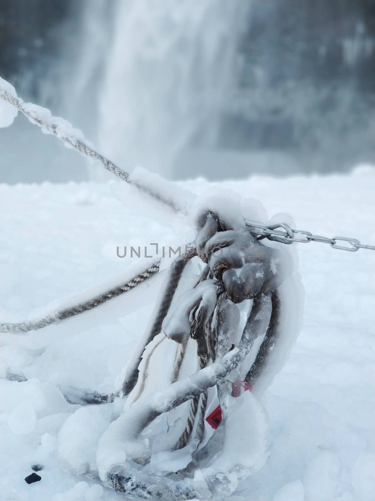 Frozen rope in winter. Huge icicles close up.