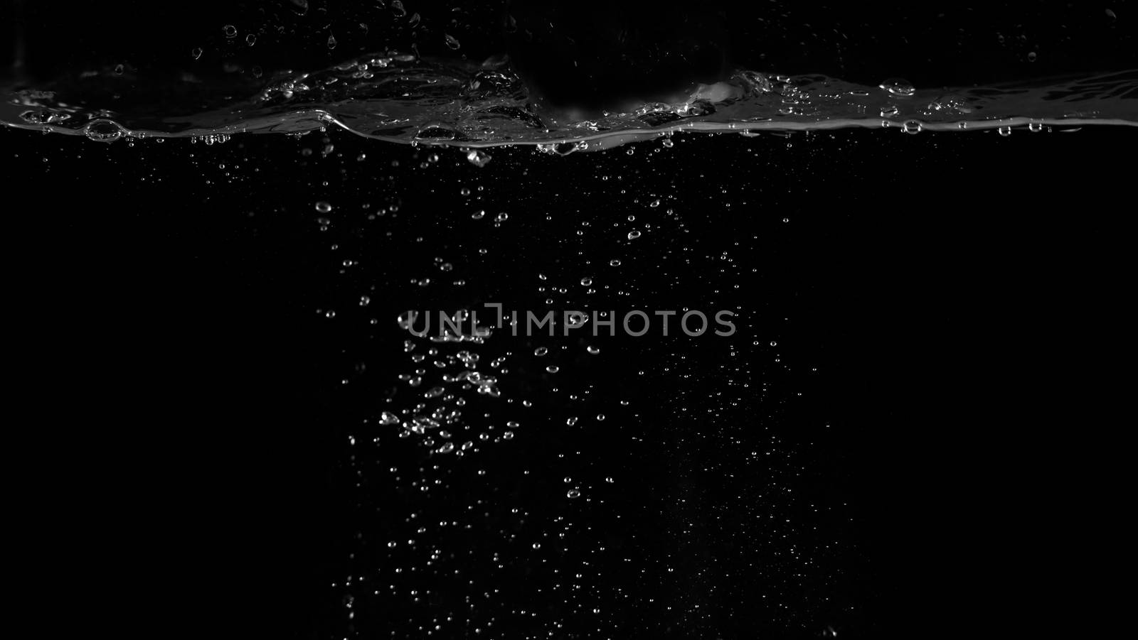 Water bubbles floating on black background which represent refreshing of refreshment from soda or carbonated drink and power of liquid that splashing or fizzing with blowing and streaming by air pump.