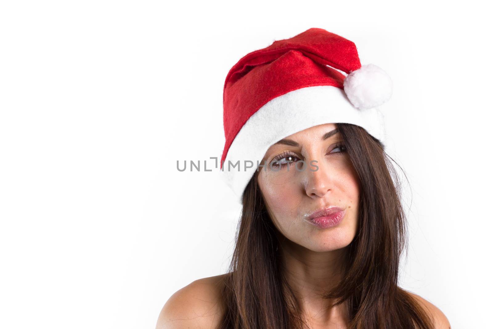 Woman with brown hair and Santa Claus hat on her head, doubtful and thoughtful.