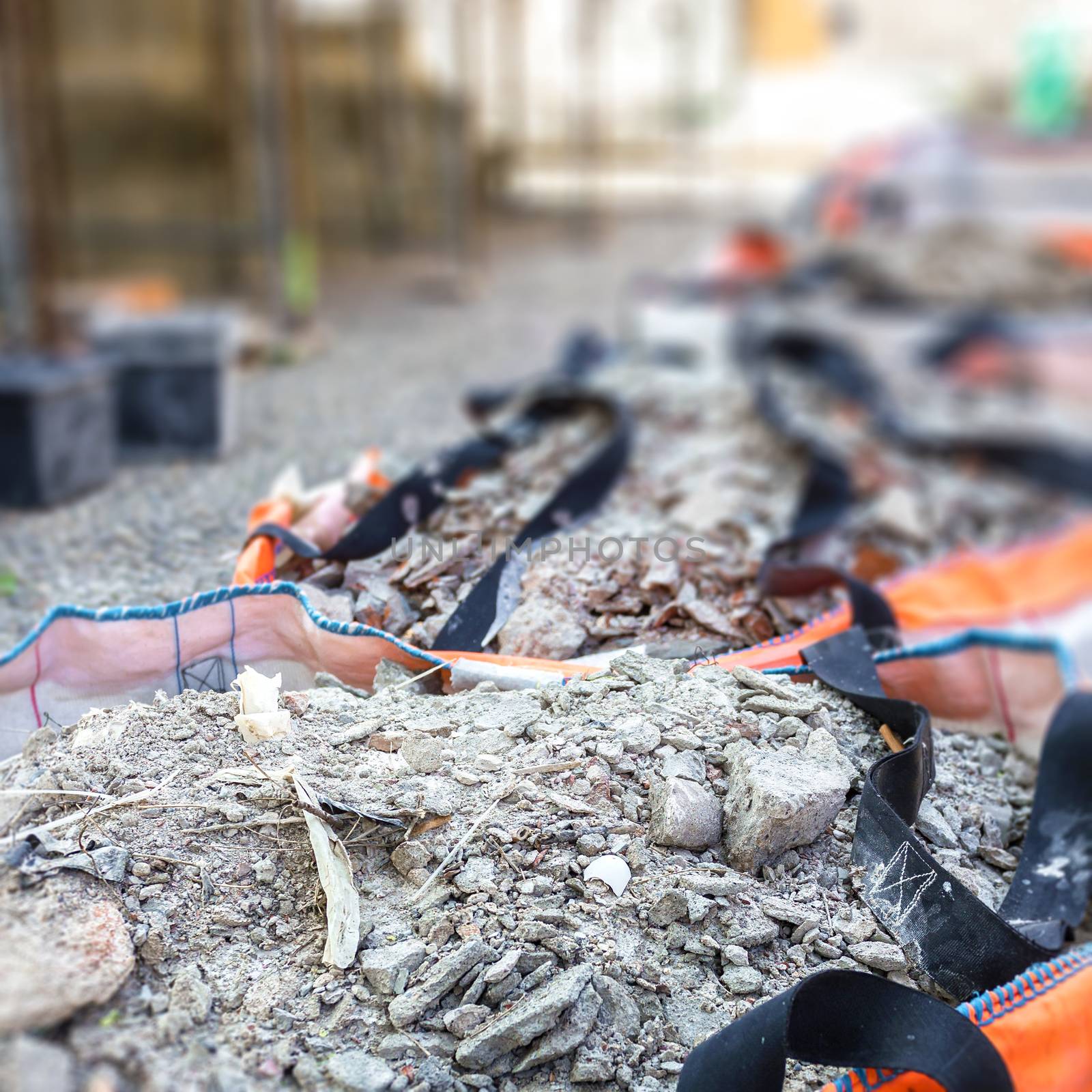 Full construction waste debris bags, garbage bricks and material from demolished house. Shallow DOF.