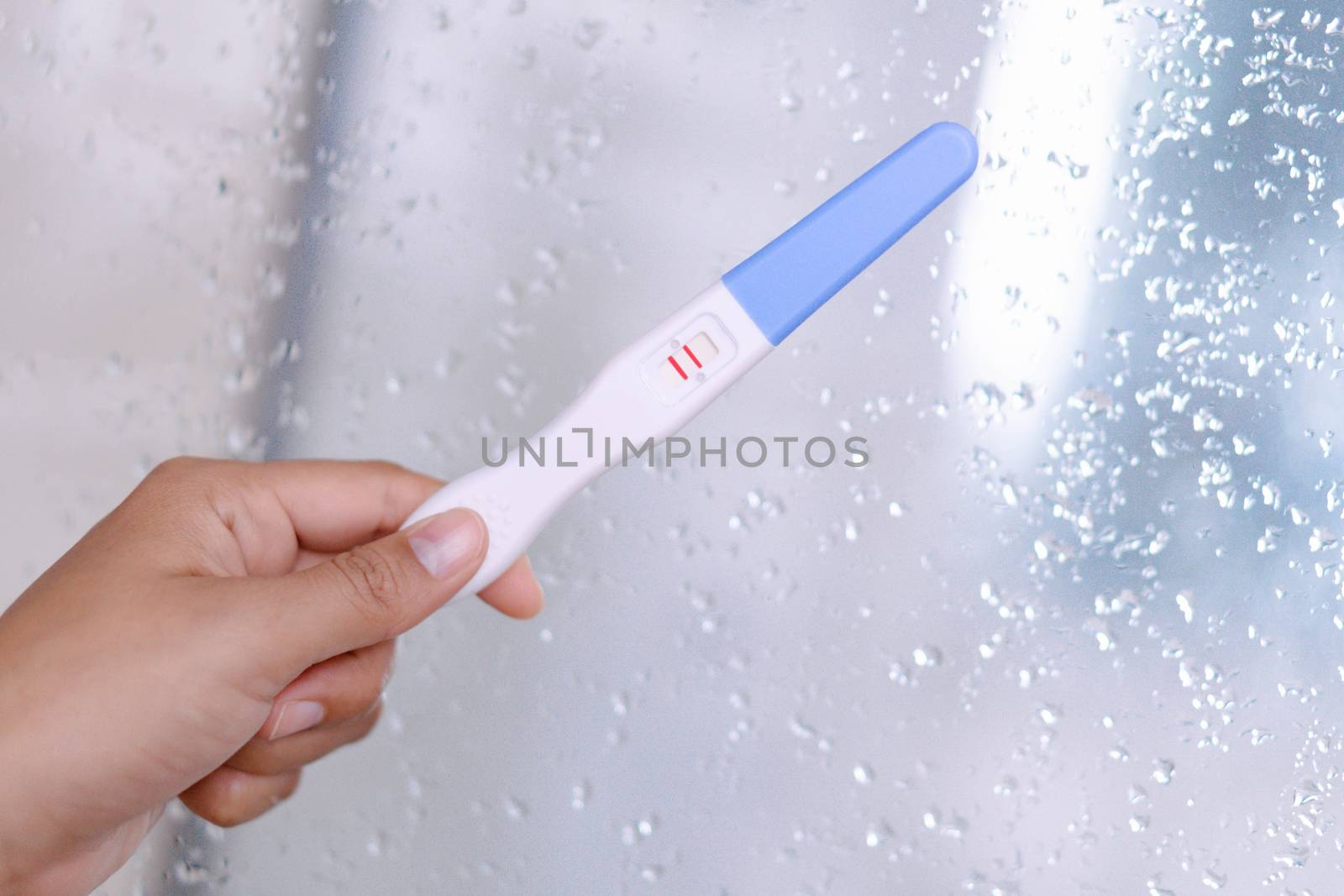 Closeup woman hand holding pregnancy test with happy moment, hea by pt.pongsak@gmail.com