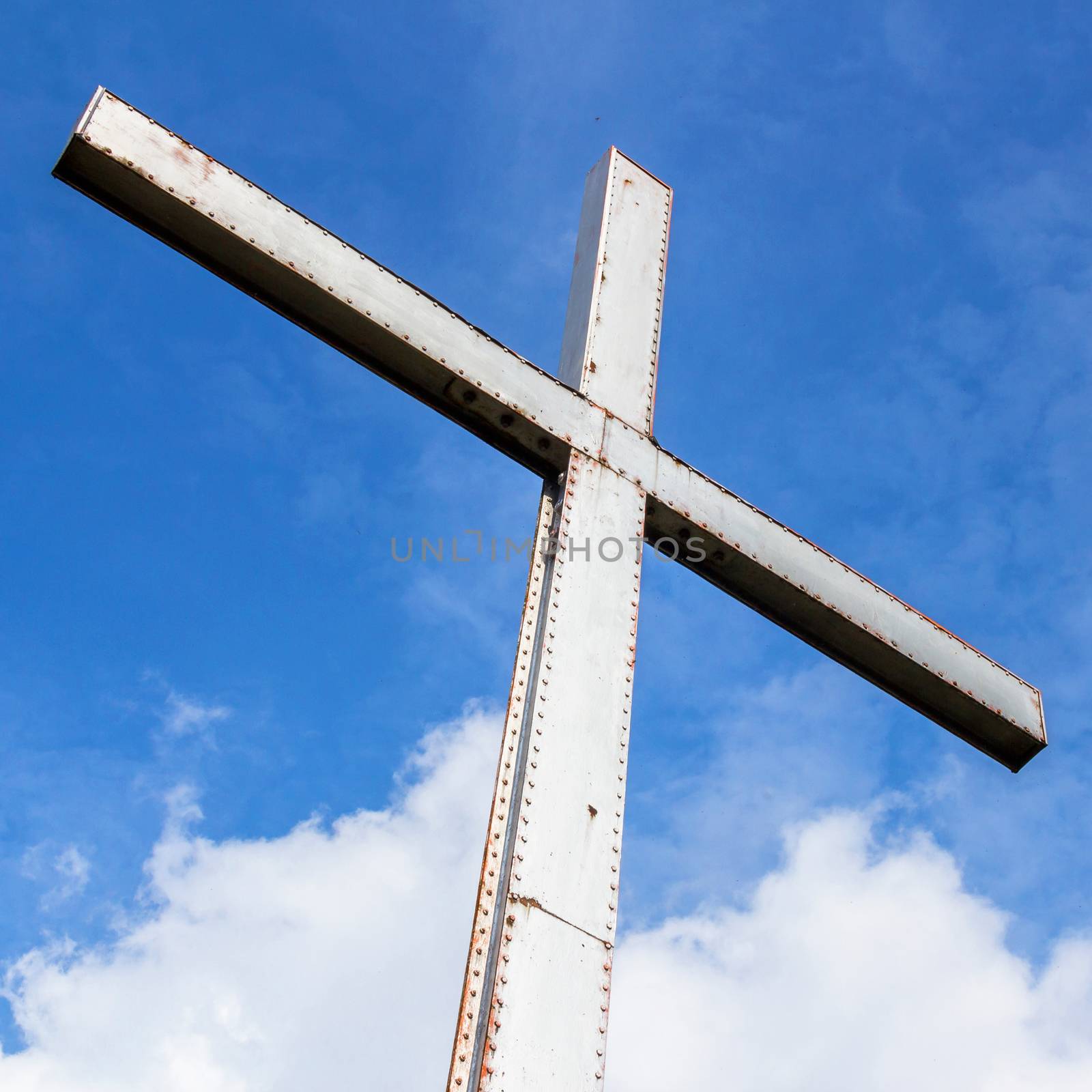 Iron cross in a cloudy sky by germanopoli