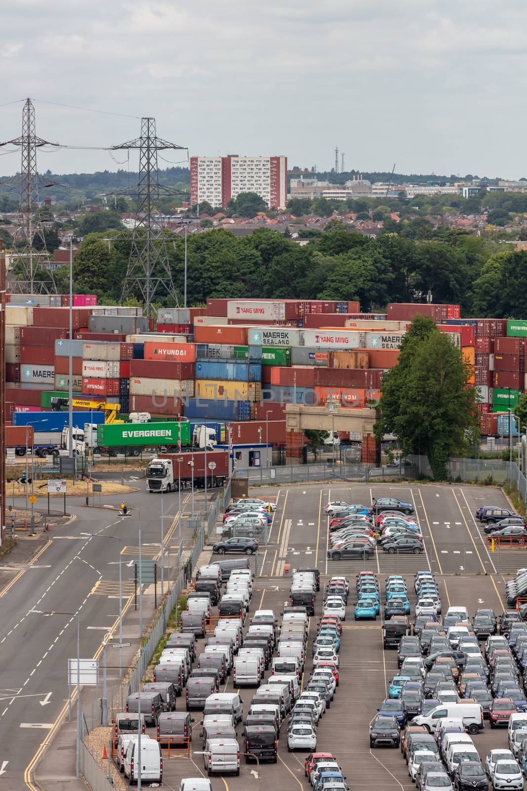 Parking lot full of cars in the port of Southampton. by DamantisZ