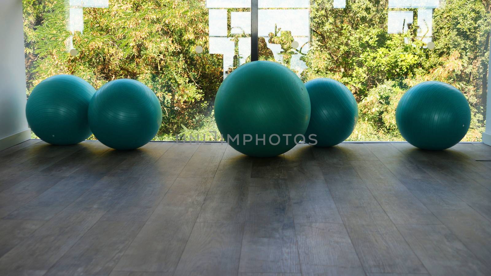 fitness balls by the window in the gym close-up by Annado