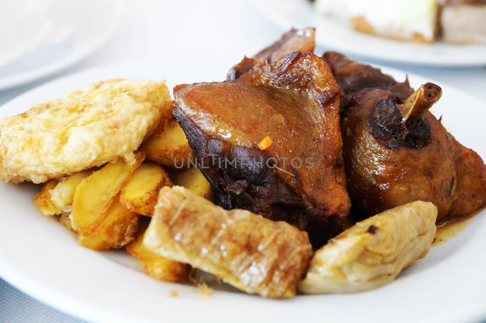 baked potatoes with meat on a white dish close-up