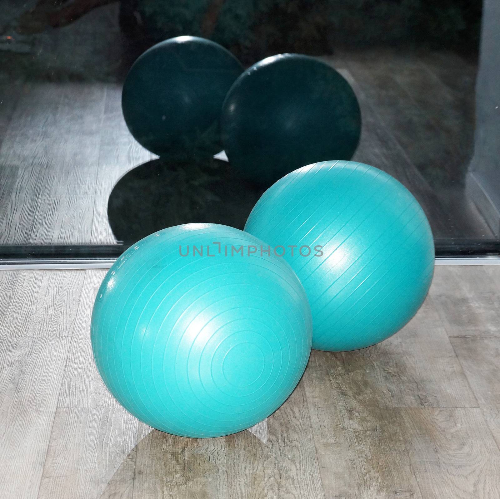 fitness balls by the window in the gym close-up by Annado