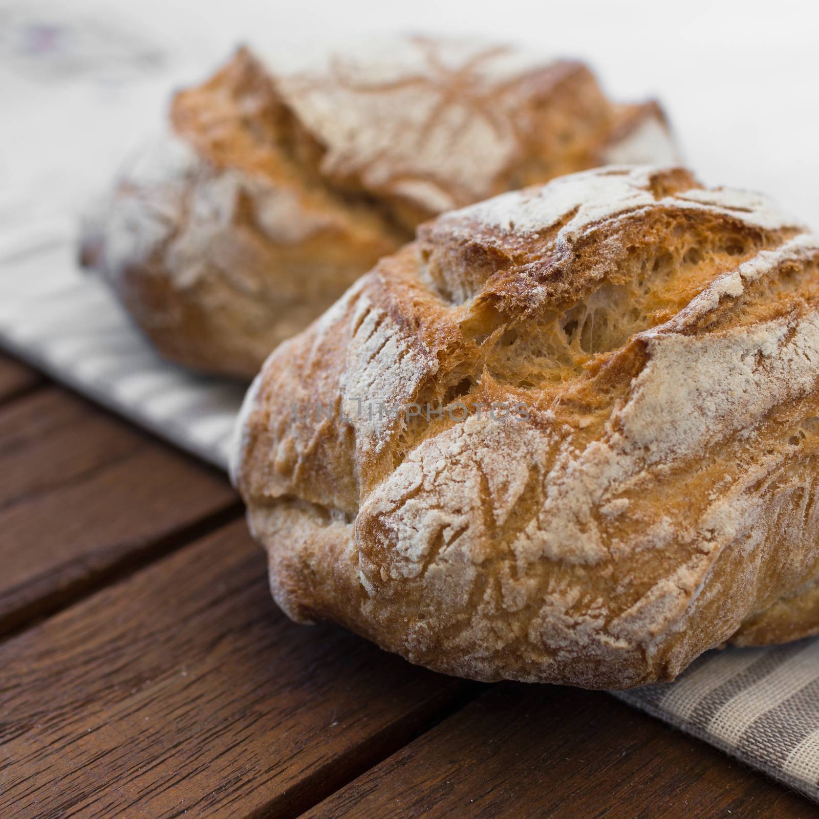 Extreme clos-up of rustic Italian bread, isolated on background out of focus.