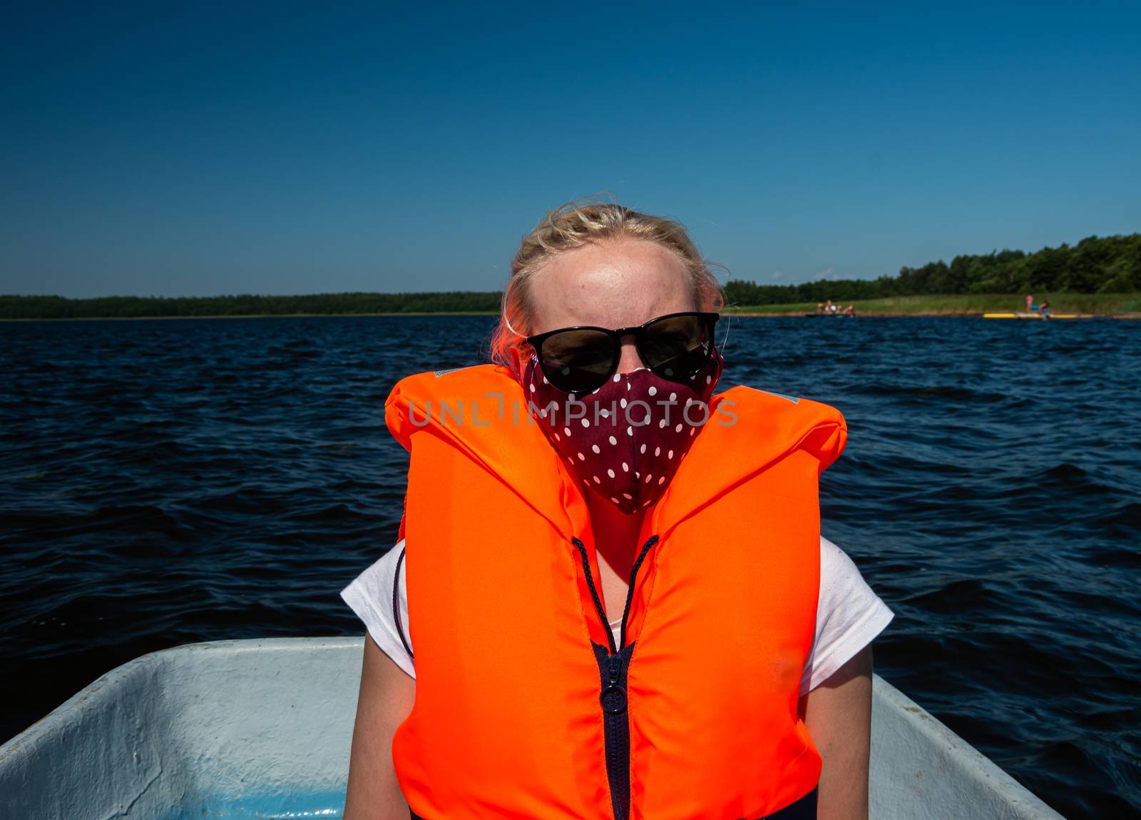 Woman in the lake with life jackets and face mask, Covid-19, coronavirus, water