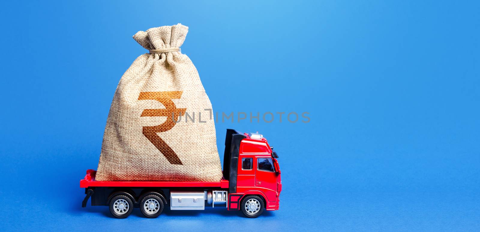 Truck is carrying a huge indian rupee money bag. Great investment. Attracting large funds to the economy for subsidies, support and cheap soft loans for businesses. Anti-crisis measures of government. by iLixe48