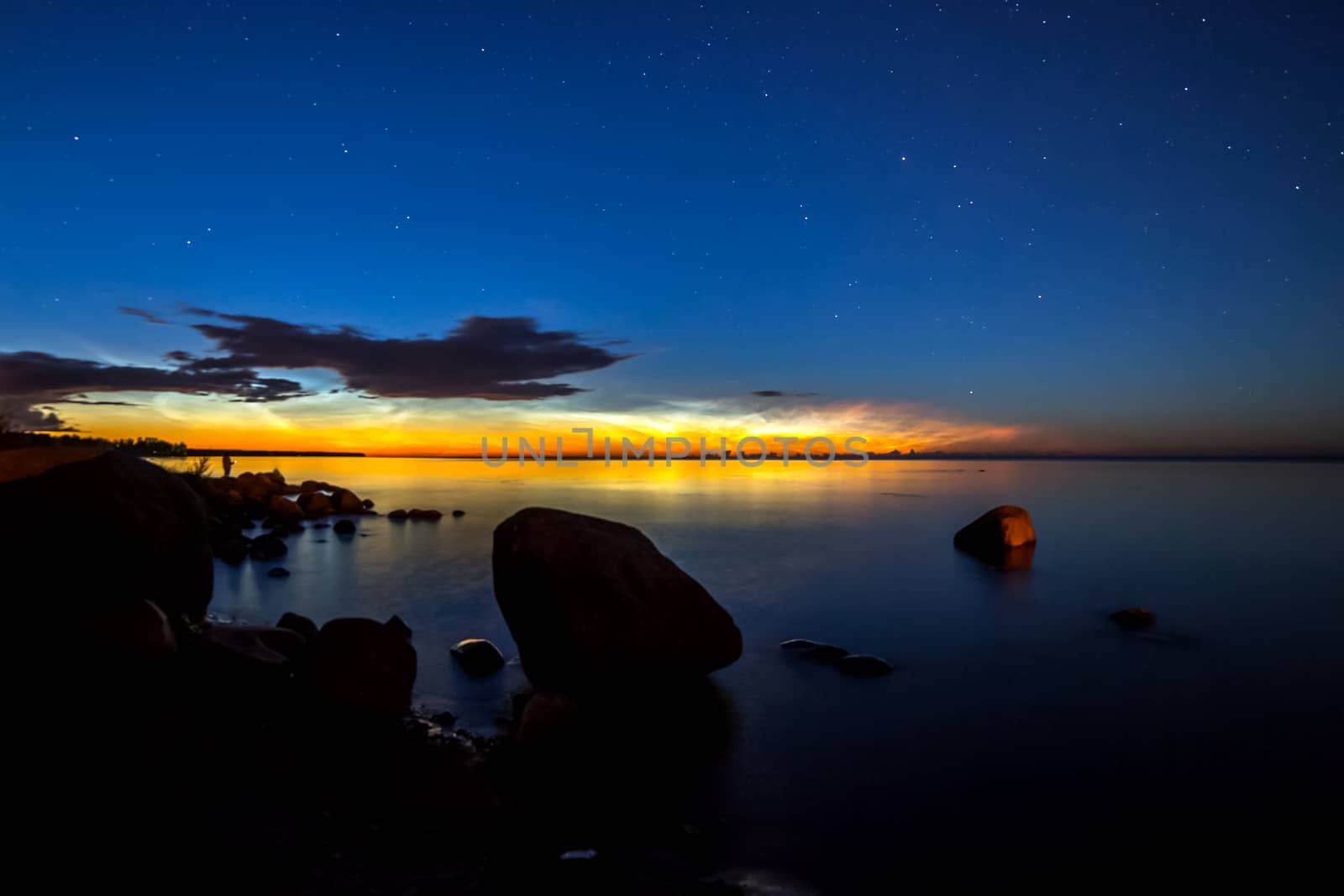 Dawn on lake. Feathered clouds glow at dawn. by DePo