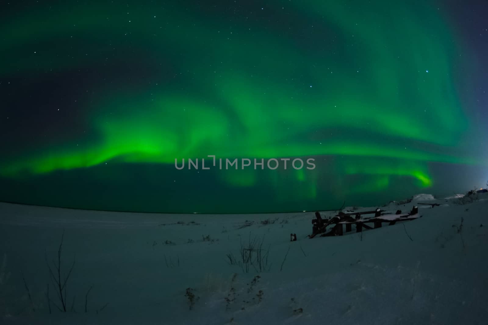 Northern Lights in the night sky. Northern Lights in the tundra.