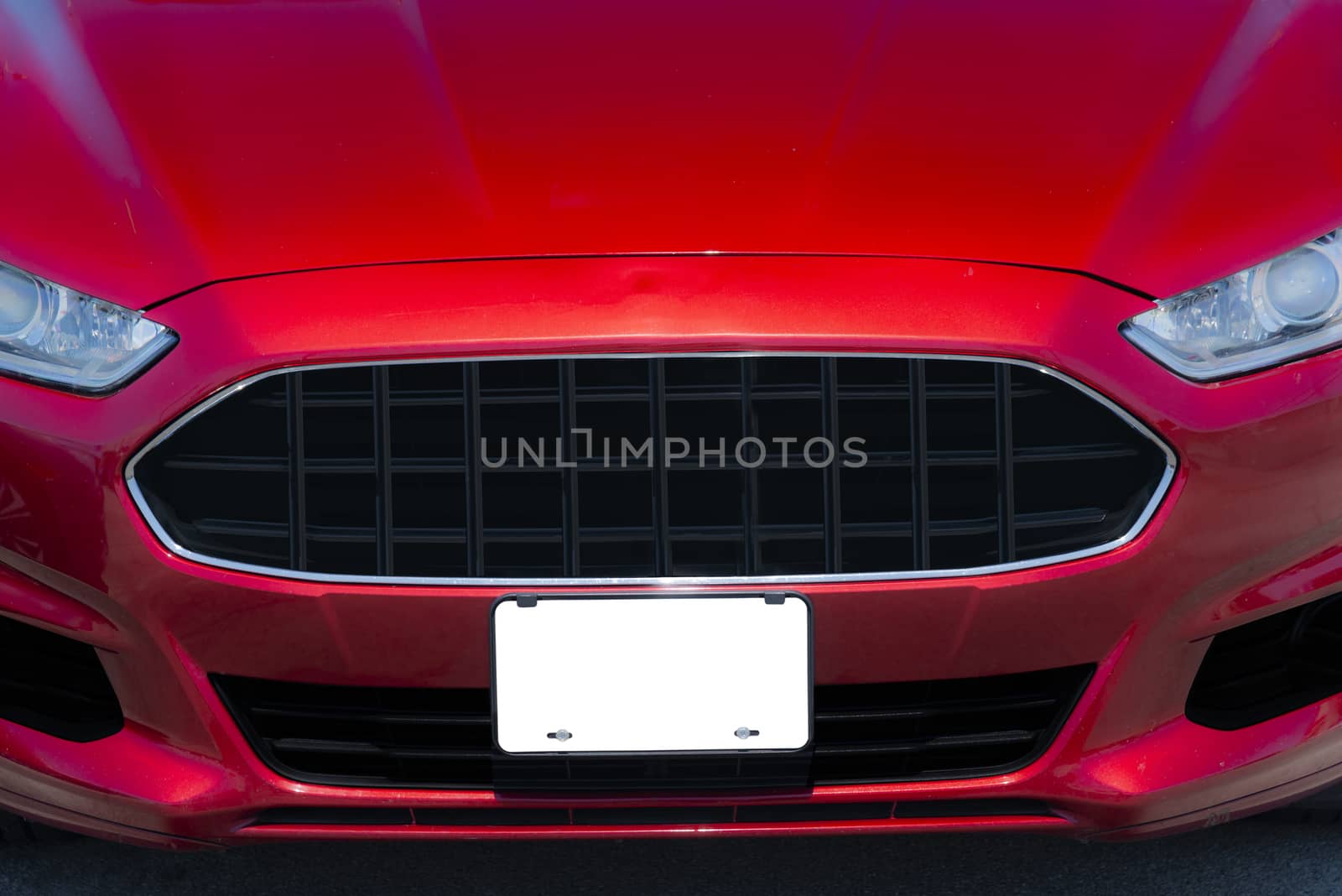 Red automobile With Blank White Front License Plate Copy Space by stockbuster1