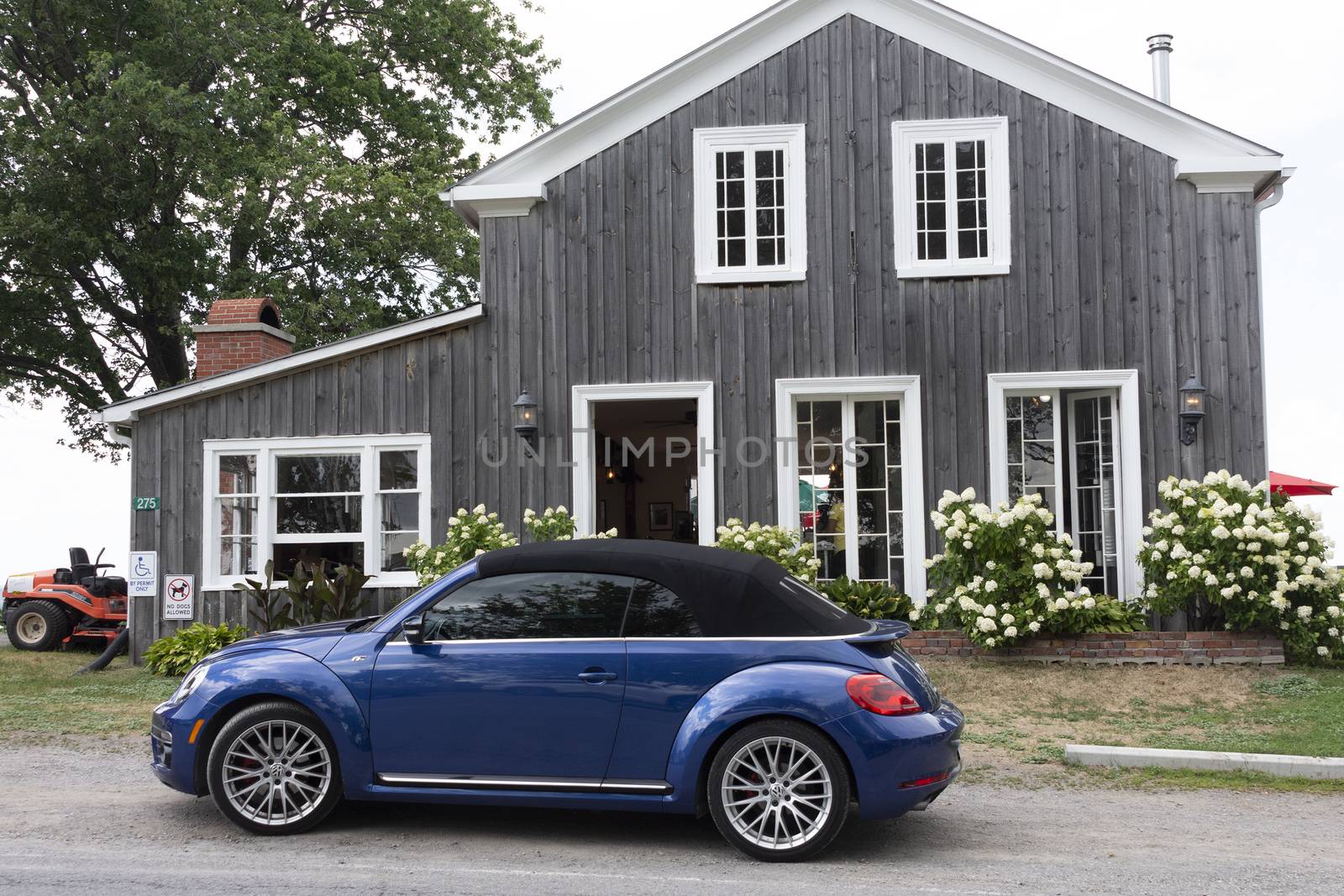 Rustic, home restaurant and shop building and a car near the entrance