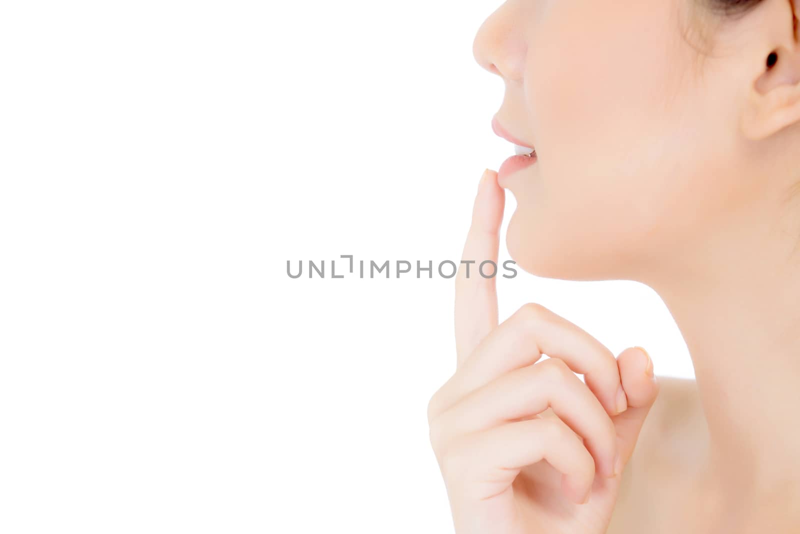 Beauty asian young woman with clean fresh skin touch lips. Cosmetology, cosmetic beauty and spa concept. Model hold a finger to mouth.
