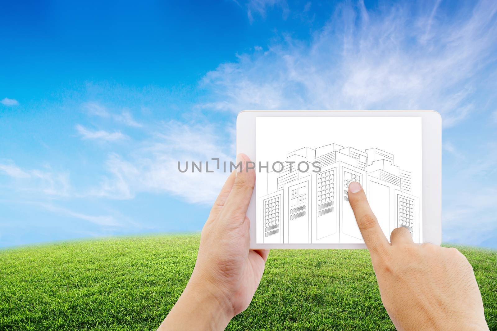 hand holding tablet of businessman with drawing sketches of construction project on nature background.