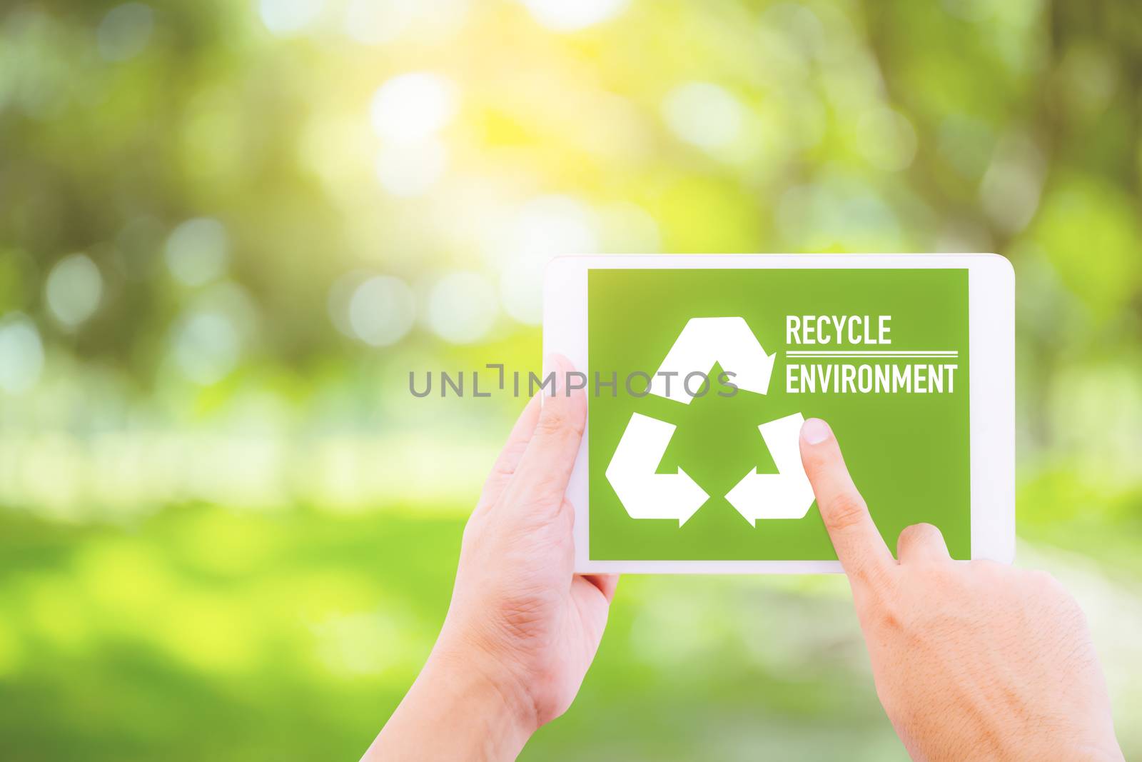 Ecology friendly recycle sign symbol with tablet holding hand, environment concept.