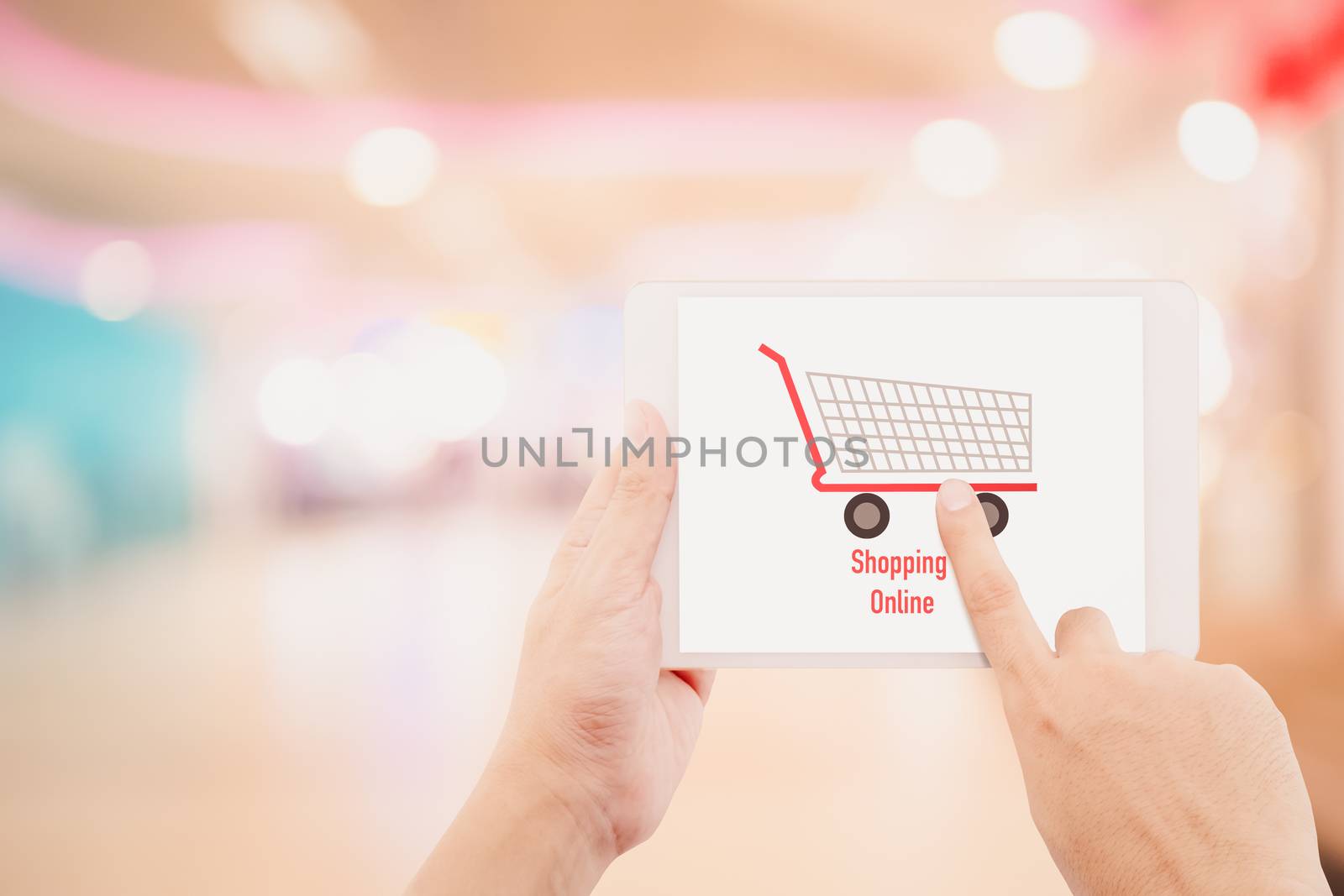 Man holding tablet, over blur or defocus image of department store or with bokeh background, shopping online concept.