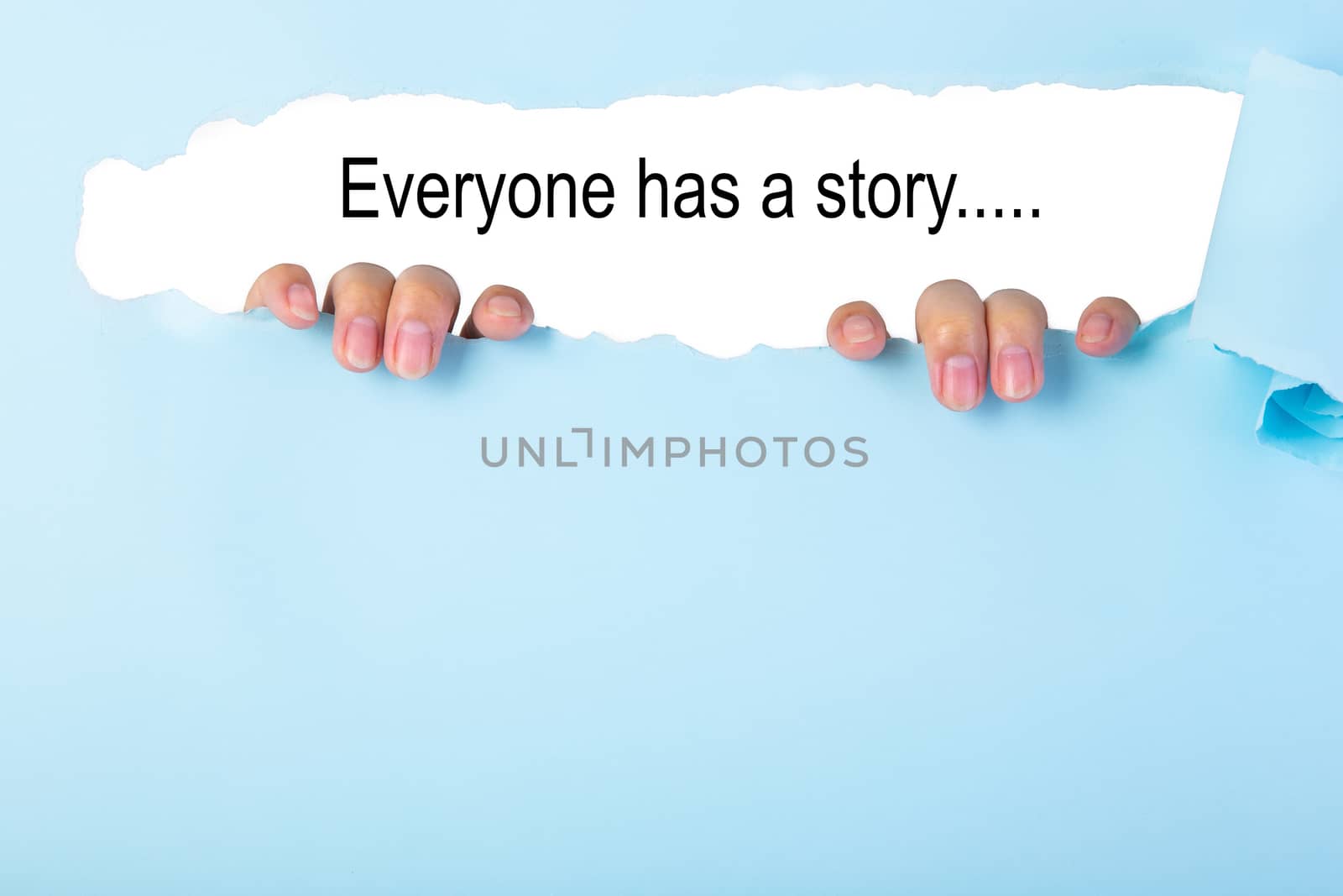 EVERYONE HAS A STORY text on blue torn paper. Concept Image