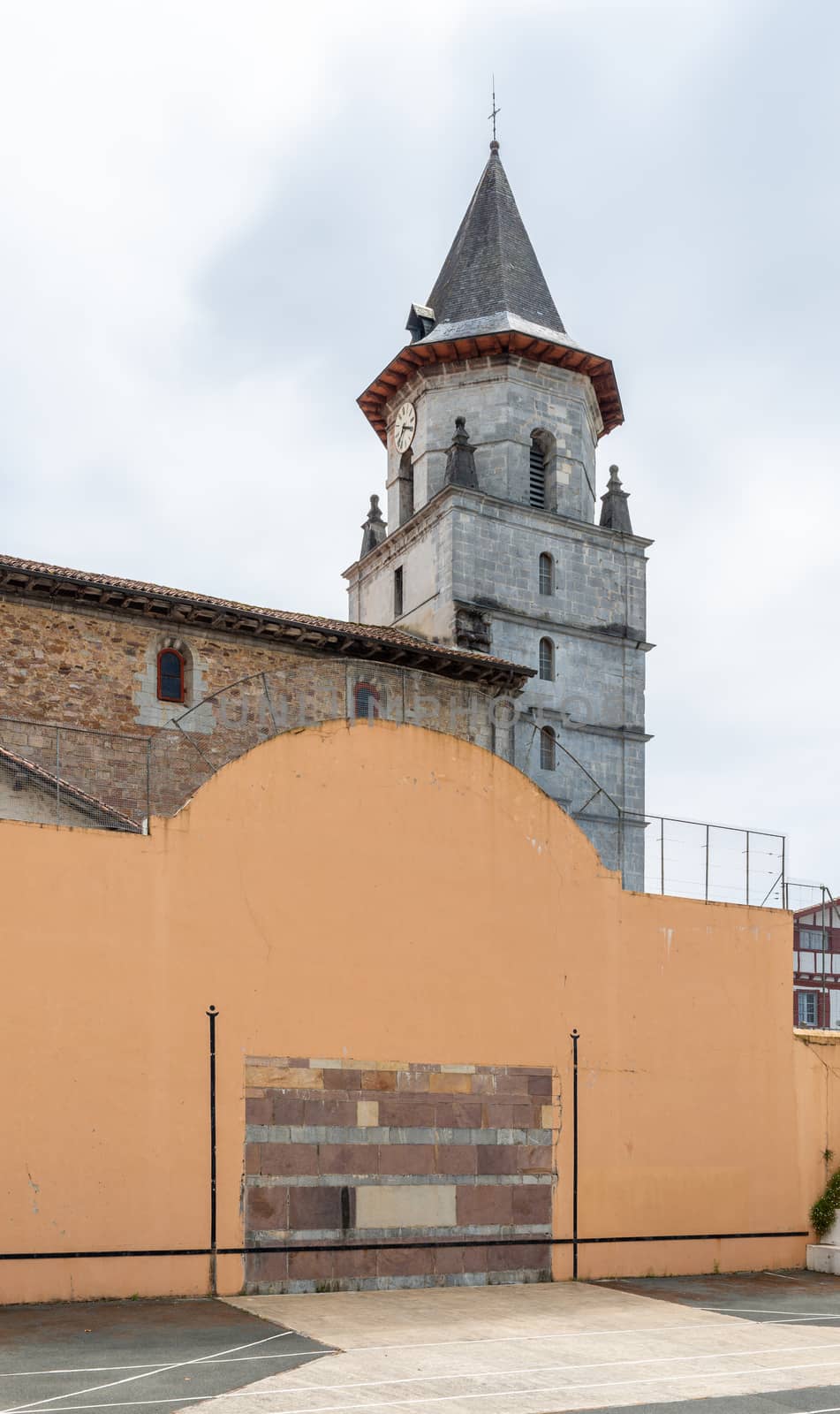 Basque pelota wall and court in Ainhoa, France. Church in the background.