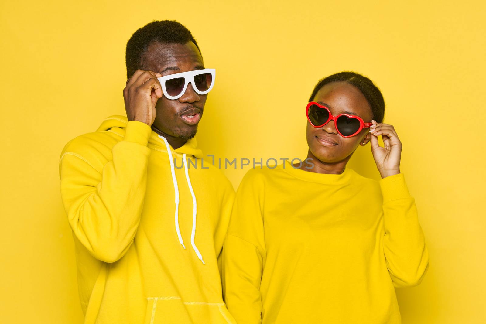 Man and woman african appearance yellow isolated background communication by SHOTPRIME