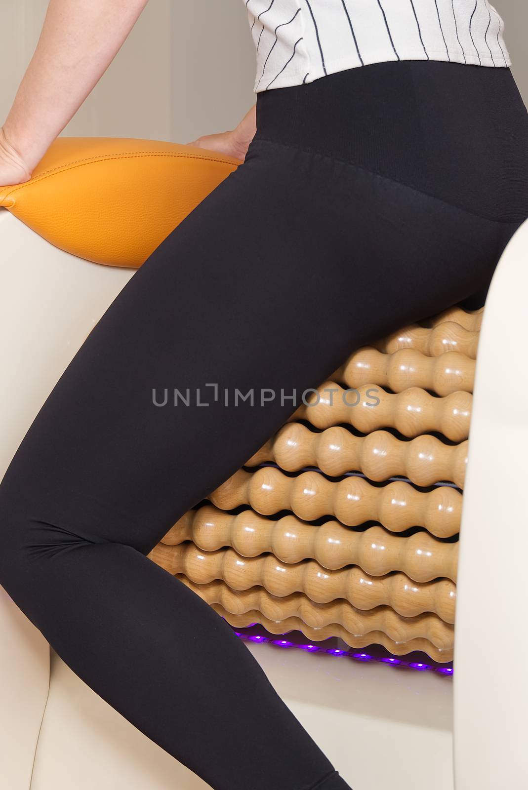 woman making massage for leg fits. Roll Massage machine is a way to shape the figure. Skin Care, body care concept. modern relax massage equipment. by PhotoTime